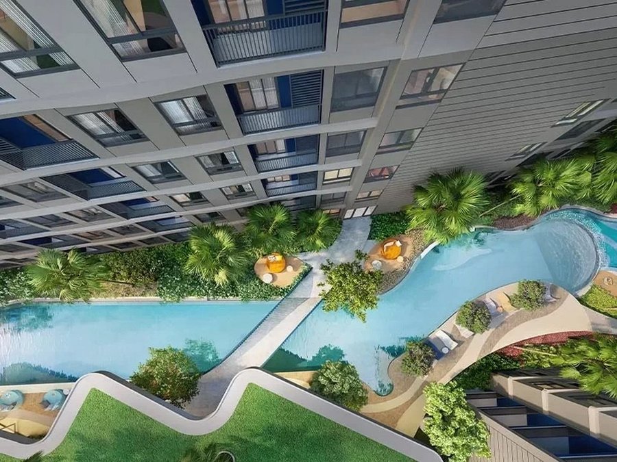 Dcondo Reef — aerial view of the pool between residential buildings